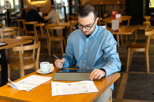 Man reviewing financial statements and working remotely