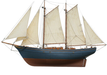 Isolated model sailboat on display with tan sails and blue hull in nautical theme style