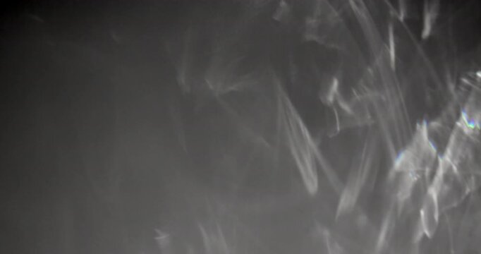 Glittering caustic FX on dark background. Abstract caustic reflections on black. Can be used as overlay elements for your projects, video texture or background for designs, scenes, etc. 