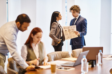 Busy professionals engage in discussion at a contemporary office during a work meeting