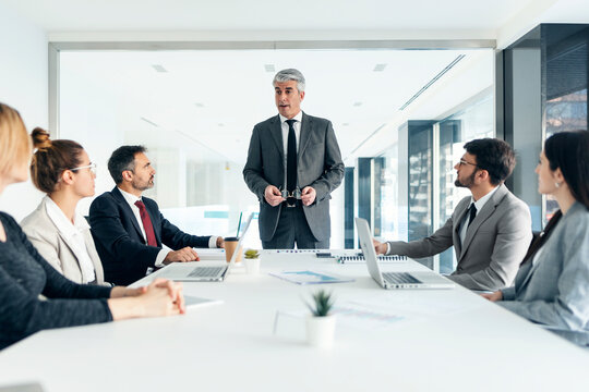 Executive leading business team meeting and brainstorming in office