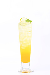 Orange flavored syrup mixed with soda in a clear glass, topped with parsley and lemon in white background