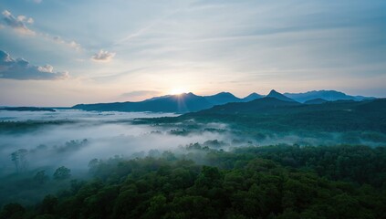 Obraz premium Morning fog enveloping a mountainous landscape from an aerial perspective, seasonal change