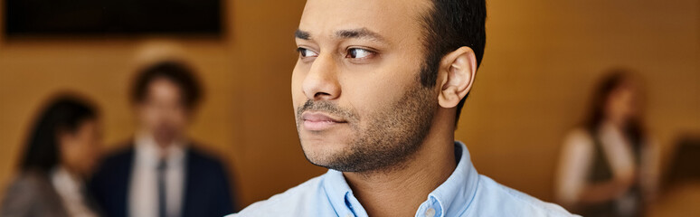 Obraz premium Focused professional in a modern office setting during a busy workday with colleagues