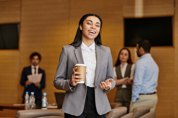 Business professionals engage together in a modern office setting with a positive atmosphere