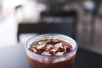 Closeup of a glass of iced coffee on the table in cafe