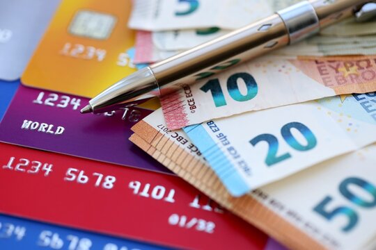 Credit cards and pen with euro currency money bills banknotes. Business, financial operations and accounting in European Union