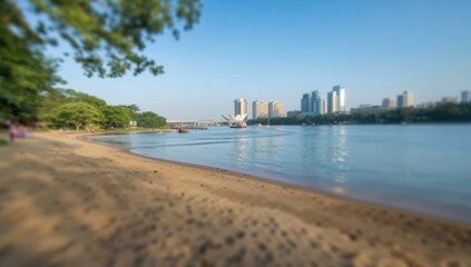 River and beach at sunrise with blurred figures, leisure activity and water reflection