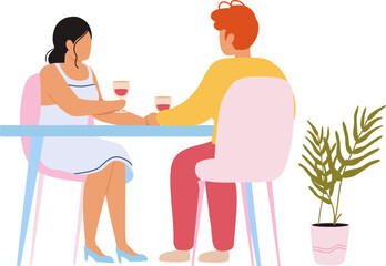 Romantic couple holding hands on date drinking wine