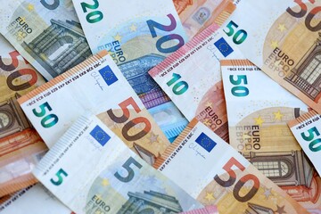 Euro money bills banknotes in big amount on table close up. Huge quantity of European Union currency cash on smooth surface. Business and rich life concept