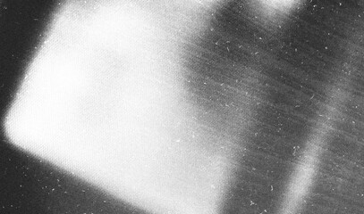 Stippled grain texture background. Black sprayed dots gradient wallpaper. Rough noisy sand dotted...