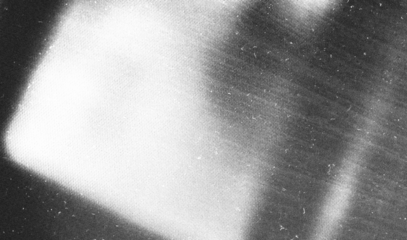 Stippled grain texture background. Black sprayed dots gradient wallpaper. Rough noisy sand dotted backdrop.