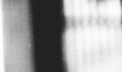 Stippled grain texture background. Black sprayed dots gradient wallpaper. Rough noisy sand dotted backdrop.