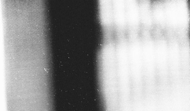 Stippled grain texture background. Black sprayed dots gradient wallpaper. Rough noisy sand dotted backdrop.