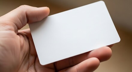 Hand holding blank white card for information or identification