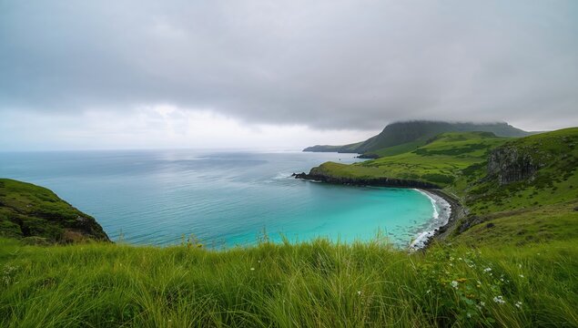 Under a cloudy sky, a serene ocean lies embraced by lush green hills, seasonal change