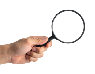 Hand holding magnifying glass, searching for details