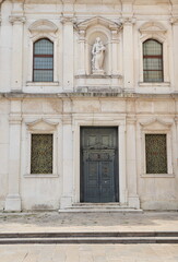 San Giacomo Apostolo Church Facade Detail with Entrance and Statue in Udine, Italy