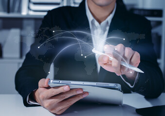 Businessman Connecting Global Business Network and Digital World Map on Tablet Screen, Showing Concept of Worldwide Communication Strategy, Technology, International Partnership, and Global Logistics.