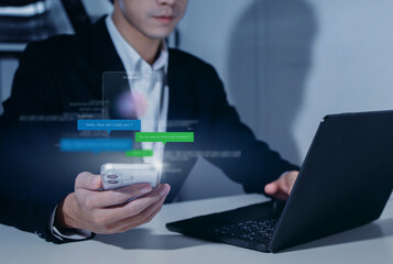 Businessman Communicating with AI Assistant Chatbot Hologram on Smartphone while Using Laptop, Document Analysis, Business Support, Future Technology of Corporate Communication, and Digital Efficiency