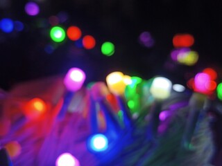 Colorful LED Fairy Lights Close-Up Festive Decorative Lights Macro Photography Glowing Bokeh Effect Holiday Celebration Background