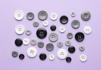 Many sewing button in grayscale tones on purple background for craft, fashion, or textile project design