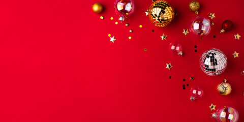 Festive Christmas ornaments on a red background.