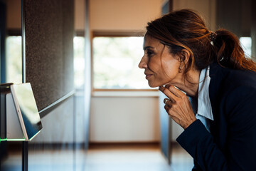 Businesswoman using touchscreen sensor in modern office meeting room