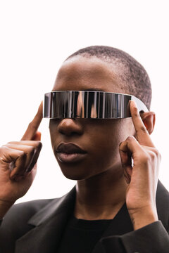 Young woman with smart glasses against white background