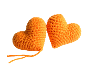 Two knitted orange hearts with strings