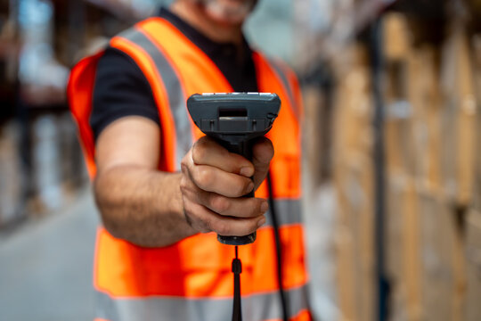 Warehouse worker scanning barcodes managing inventory and logistics