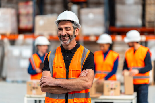 Warehouse worker smiling standing with arms crossed