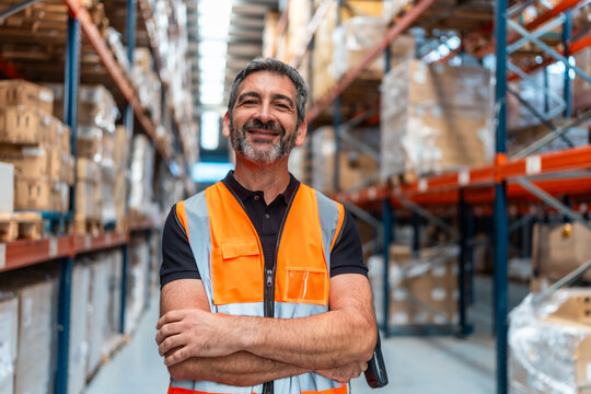 Confident man working in logistics warehouse - Powered by Adobe