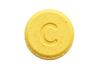Isolated yellow pill with a letter C stamped on it, medicine or vitamin, health care concept