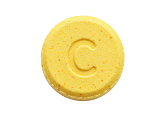 Isolated yellow pill with a letter C stamped on it, medicine or vitamin, health care concept