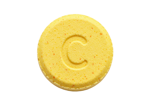 Isolated yellow pill with a letter C stamped on it, medicine or vitamin, health care concept