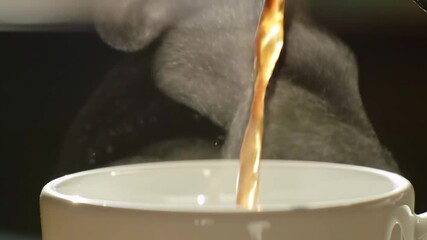 Close-up shot of hot coffee being poured into a white ceramic mug, creating steam and a comforting morning ritual, perfect for caffeine lovers