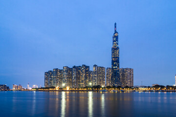 Obraz premium Saigon, Vietnam - 11 Nov, 2025 - Evening skyline view of Landmark 81 and surrounding high-rise buildings reflecting on the Saigon River in Binh Thanh District.