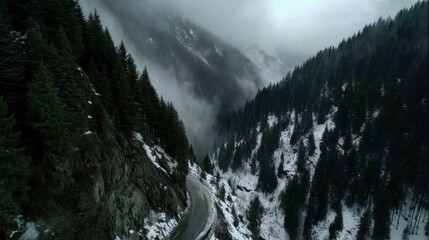 Winding road through snowy mountains serene landscape aerial view majestic nature scenery tranquil environment