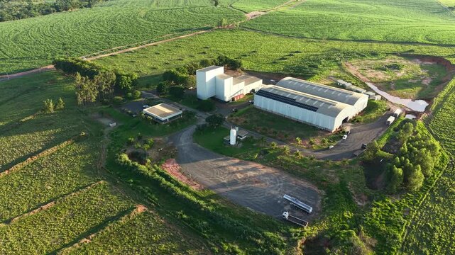 Aereal view aerial view of industrial buildings amidst green fields and vegetation landscape scene shot
