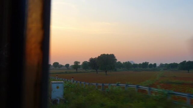 A scenic view of an Indian train running through Rajasthan with the Aravalli Range in the background. The landscape blends nature and travel, showing the beauty of India&rsquo;s rail journeys.