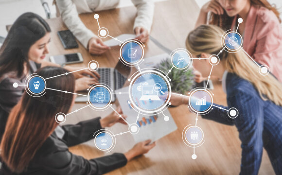 A diverse group of professionals engage in a collaborative business meeting, analyzing data and discussing innovative strategies in a modern office setting. Tessel