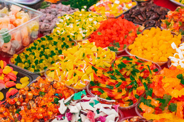 colorful jelly and gummy candies on red tablecloth at vietnam fair