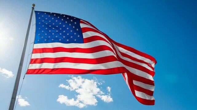 Majestic american flag waving in bright sky with floating clouds