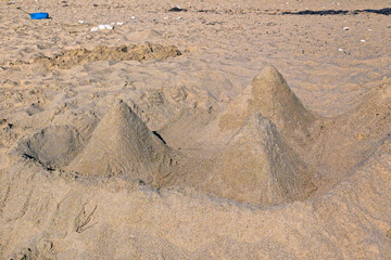 Pyramids made of sand on the beach