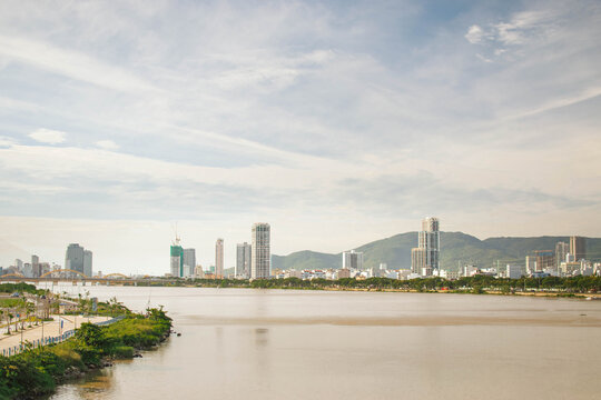 river view in danang with distant buildings, park, and mountains