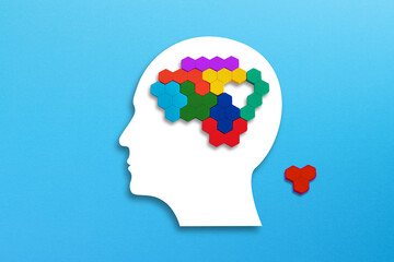 Mental health concept. Human brain made of multi-colored wooden blocks. Missing piece of the brain puzzle.