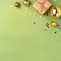 Christmas gift with gold ornaments on a green background.