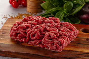 Raw minced beef meat over board