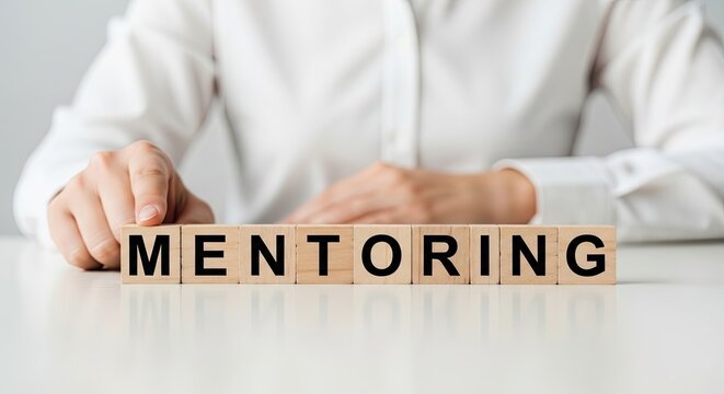Business pro arranging wooden blocks spelling mentoring word. - Powered by Adobe